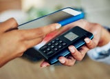 Person using a card machine to accept a mobile payment