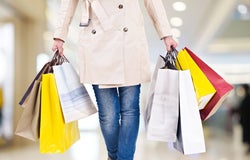 Customer carrying multiple shopping bags