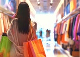 Customer in a clothes shop carrying bags